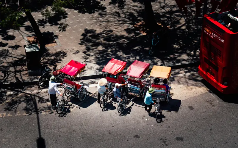 Cyclos lined up on a street in Hanoi's Old Quarter, seen from above